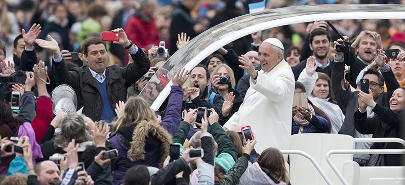 Pope Francis rides through adoring crowds after mass on Easter Sunday on April 5 . The Argentine, known for riding in cost efficient cars and staying in simple apartments, will address the United States Congress in September about environmental issues. (AP Photo/Andrew Medichini)