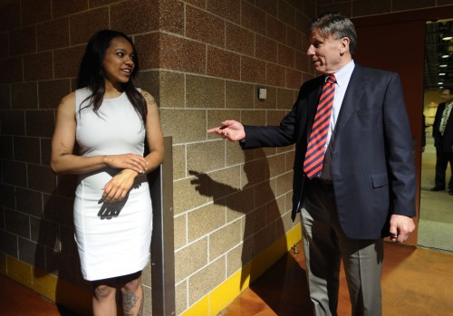 DePaul coach Doug Bruno, right, informs former player Brittany Hrynko that she had traded to the Atlanta Dream at the end of the WNBA basketball draft, Thursday, April 16, 2015, in Uncasville, Conn. (AP Photo/Jessica Hill)