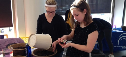 Freshmen Sammie Dinning and Megan Kerber plant herb seeds at the Ray. Both are passionate about the environment, and Kerber considers recycling more than a chore; she collects bottles around her Chicago neighborhood because her alderman doesn’t provide recycling bins. (Megan Deppen / The DePaulia)