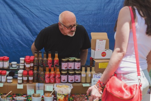 Guests peruse offerings ranging from hot sauce to bourbon to organic produce at the Green City Market in Lincoln Park. (Olivia Jepson / The DePaulia)