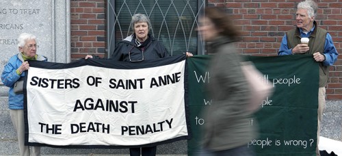 Protestors stand outside the trial of surviving Boston Marathon bomber Dzhokhar Tsarnaev. Many in the Christian community have driven anti-death penalty activism, despite common labeling as conservatives. (AP Photo/Justin Saglio)