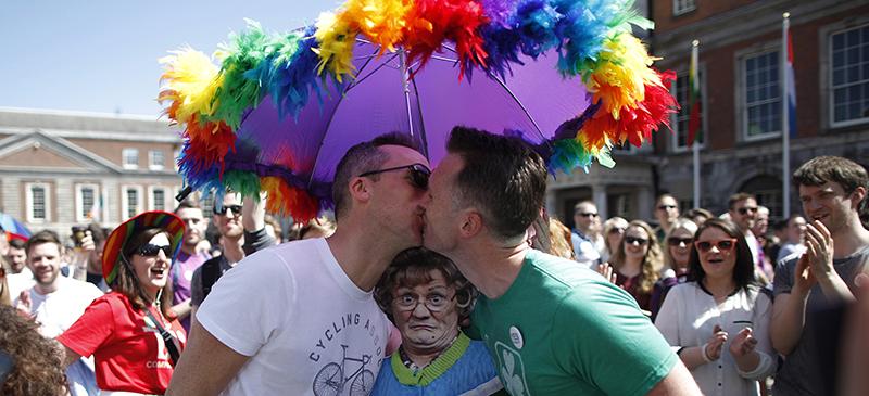 Two Irish men kiss in celebration of the referendum results approving of gay marriage in their country Saturday, May 23. (AP Photo/Peter Morrison, FILE)