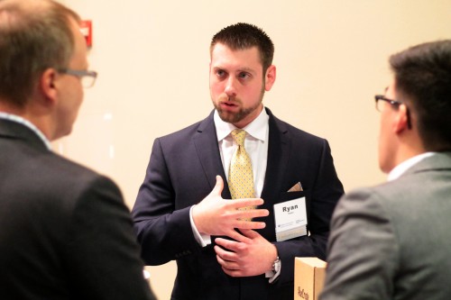 DePaul senior Ryan Siepka pitches his guitar merchandize shipment company, AxeCrate to an interested passerby at the DePaul Launch Awards. Siepka and his partner, Jesse Aquino, won second place and $2,500. (Megan Deppen / The DePaulia)