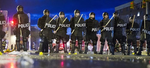 Riot police stand guard in Baltimore. Massive demonstrations ensued following the death of African-American resident Freddie Gray while in Baltimore police custody. (AP Photo/Matt Rourke)