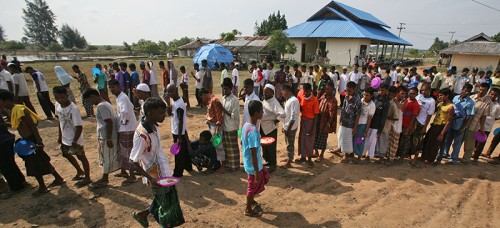 People wait for water at a refugee camp for Rohingyas, a persecuted Muslim minority group in Myanmar. (AP Photo/Binsar Bakkara)