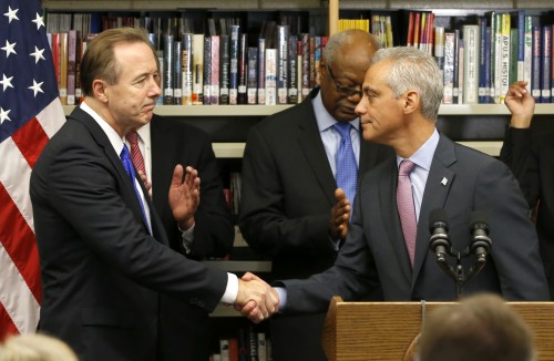 Forrest Claypool, left, shakes Chicago Mayor Rahm Emanuel's hand after Emanuel announced that Claypool will head the embattled Chicago Public Schools Thursday, July 16, 2015, in Chicago. Claypool, is currently Emanuel's chief of staff and was president of the Chicago Transit Authority during the mayor's first term. (AP Photo/Charles Rex Arbogast)