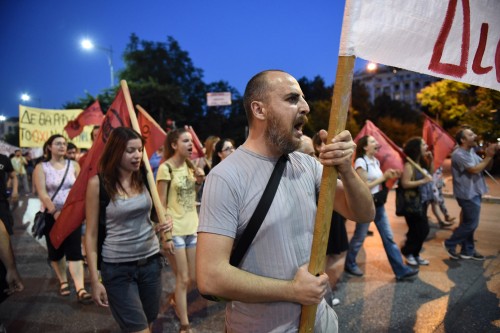 Demonstrators march during an anti-austerity rally in the northern Greek port city of Thessaloniki, Wednesday, July 15, 2015. Greece's prime minister was fighting to keep his government intact in the face of outrage over an austerity bill that parliament must pass Wednesday night if the country is to start negotiations on a new bailout and avoid financial collapse. (AP Photo/Giannis Papanikos)