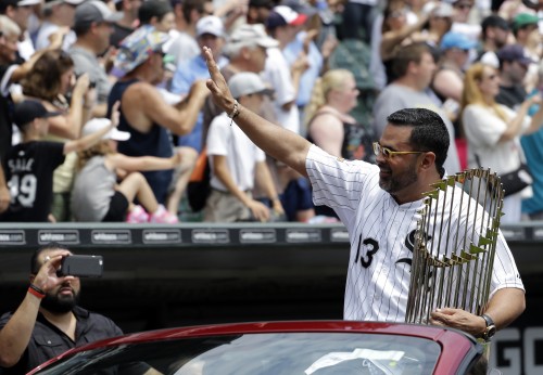 Former Chicago White Sox manager Ozzie Gullien waves to the crowd during a ceremony honoring the 10th anniversary of the 2005 World Series Champion Chicago White Sox team before a baseball game between the Kansas City Royals and the Chicago White Sox Saturday, July 18, 2015, in Chicago. (AP Photo/Nam Y. Huh)