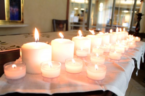 Attendees at DePaul's peace vigil for the victims of the Charleston church shooting lit tiny candles in support of the nine victims who were represented by the larger candles lit at the altar. 