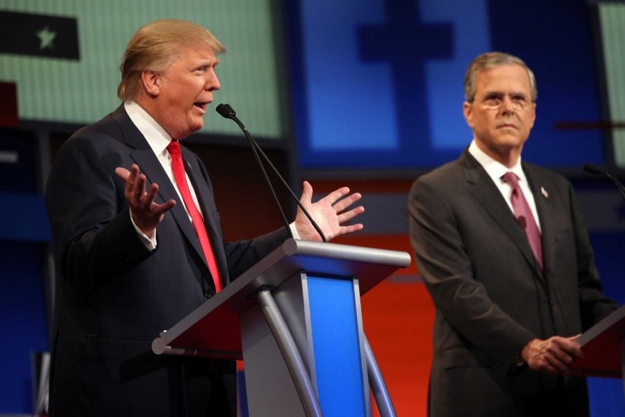 Republican presidential candidate Donald Trump speaks as  Jeb Bush watches during the FOX News Channel  Republican presidential debate at the Quicken Loans Arena Thursday, Aug. 6, 2015, in Cleveland. Republicans are steeling themselves for a long period of deep uncertainty following a raucous first debate of the 2016 campaign for president, with no signs this past weeks Fox News face-off will winnow their wide-open field of White House hopefuls anytime soon.   (AP Photo/Andrew Harnik)