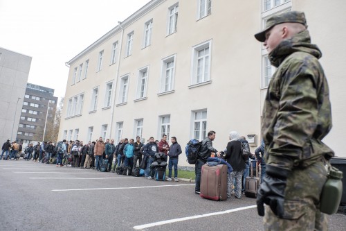 Asylum seekers queue up as they arrive at a refugee reception centre in the northern town of Tornio, Finland, on Friday Sept. 25, 2015. According to current official predictions, about 30,000 asylum seekers will arrive in Finland this year, compared to 3,651 last year. (Panu Pohjola/Lehtikuva via AP) FINLAND OUT - NO SALES
