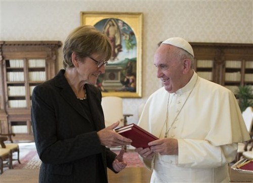 President of PACE, Parliamentary Assembly of the Council of Europe, Anne Brasseur, left, exchanges gifts witg Pope Francis during a private audience at the Vatican, Friday, Sept. 18, 2015. (L'Osservatore Romano/Pool Photo via AP)