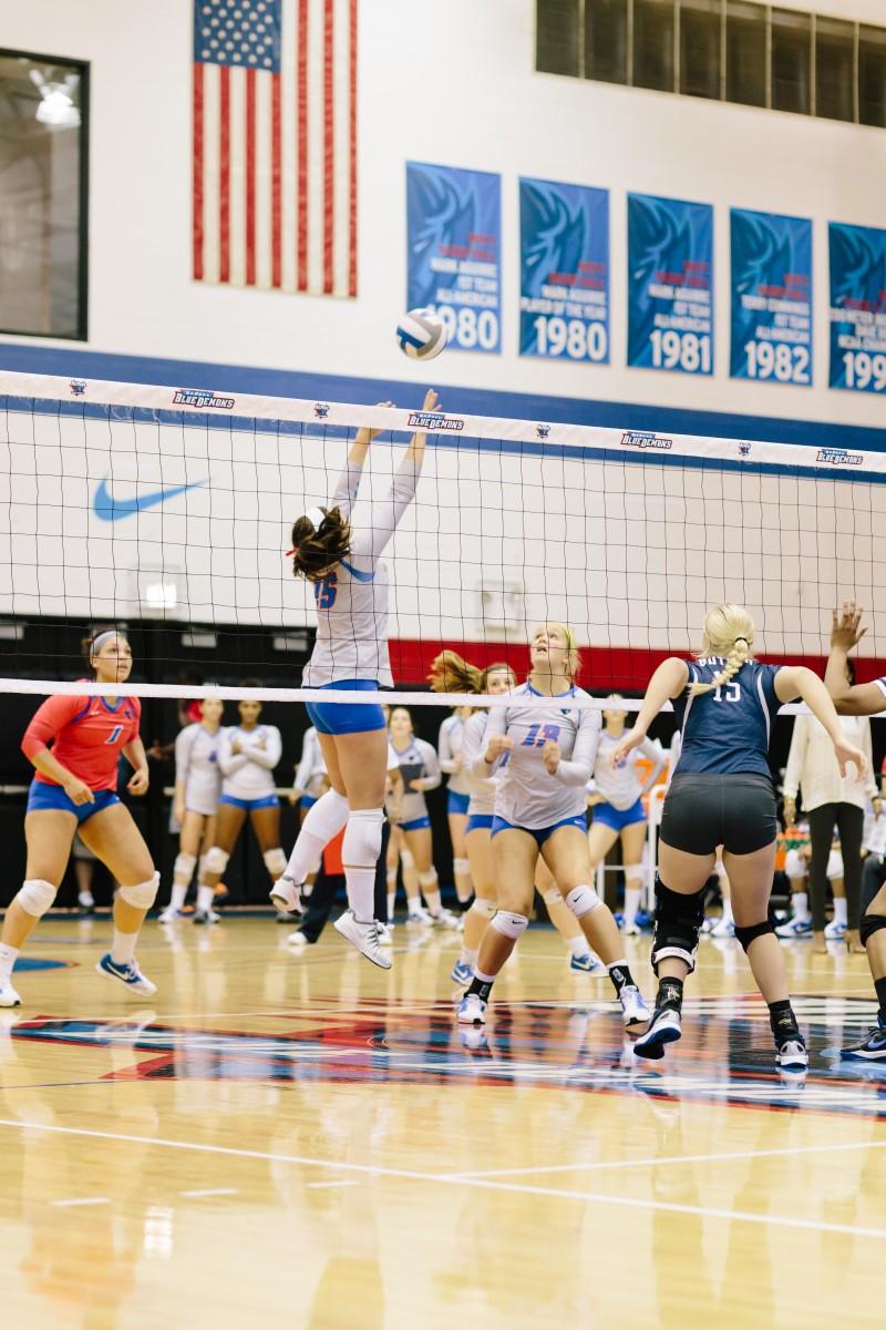 Junior Colleen Smith sets the ball as sophomore Caitlyn Coffey waits for a hit. (Photo by Garrett Duncan | The DePaulia.)