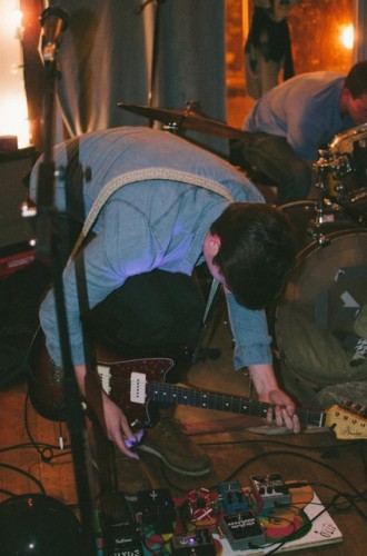 Brisco Darling guitarist and DePaul junior, Jack Hiltabidle, sets up his guitar and peddle before a show. (Photo by Yazmin Dominguez | The DePaulia.)