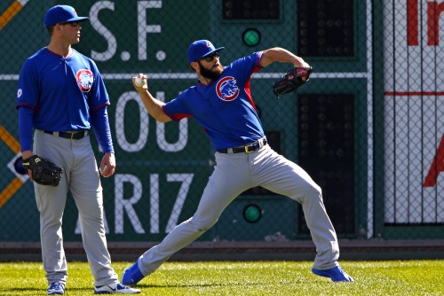 Chicago Cubs starting pitcher Jake Arrieta, right, throws in the outfield with Clayton Richard watching during workout day, Tuesday, Oct. 6, 2015, for Wednesday's National League Wild Card baseball game against the Pittsburgh Pirates at PNC Park in Pittsburgh.(AP Photo/Gene J. Puskar)