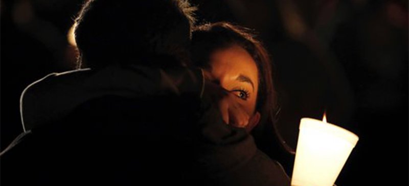 Umpqua Community College student Nichole Zamarripa, right, is consoled during a candlelight vigil for those killed during a shooting at the school, Thursday, Oct. 1, 2015, in Roseburg, Ore. (AP Photo/Rich Pedroncelli)