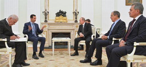In this photo taken on Tuesday, Oct. 20, 2015, Syria President Bashar Assad, center left, gestures during his meeting with Russian President Vladimir Putin, center right, as Russian Foreign Minister Sergey Lavrov, second from right, and Russian Defence Minister Sergei Shoigu, right, listen in the Kremlin in Moscow, Russia. President Bashar Assad was in Moscow, in his first known trip abroad since the war broke out in Syria in 2011, to meet his strongest ally Russian leader Vladimir Putin. The two leaders stressed that the military operations in Syria_ in which Moscow is the latest and most powerful addition_ must lead to a political process. (Alexei Druzhinin, RIA-Novosti, Kremlin Pool Photo via AP)