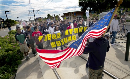 Near the Lexington light rail station in St. Paul, Minn., protesters with Black Lives Matters block traffic to and from TCF Bank Stadium before an NFL football game between the Minnesota Vikings and the Detroit Lions on Sunday, Sept. 20, 2015. Black Lives Matter St. Paul staged a die-in on the Green Line light-rail tracks to protest what they consider excessive force by Metro Transit police officers who arrested a boy with autism there Aug. 31. (Richard Tsong-Taatarii/Star Tribune via AP) MANDATORY CREDIT; ST. PAUL PIONEER PRESS OUT; MAGS OUT; TWIN CITIES LOCAL TELEVISION OUT