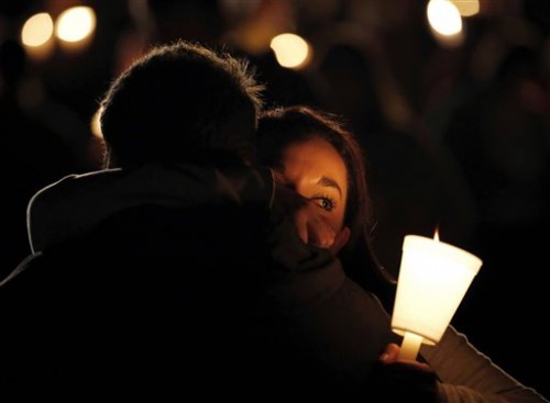 Umpqua Community College student Nichole Zamarripa, right, is consoled during a candlelight vigil for those killed during a shooting at the school, Thursday, Oct. 1, 2015, in Roseburg, Ore. (AP Photo/Rich Pedroncelli)