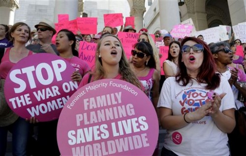 Planned Parenthood supporters rally for women's access to reproductive health care on ``National Pink Out Day'' at Los Angeles City Hall, Tuesday, Sept. 29, 2015. (AP Photo/Nick Ut)