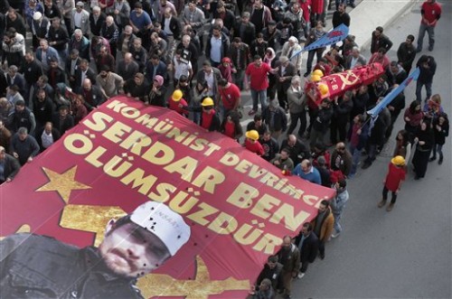 Mourners carry the coffin of Serdar Ben, 33, one of the victims of Oct. 10 bombings in Ankara, during his funeral in Istanbul, Thursday, Oct. 15, 2015. The banner reads in Turkish: ' Communist Revolutionary Serdar Ben is immortal'. The twin explosions in the Turkish capital ripped through a crowd of activists rallying for increased democracy and an end to violence between Kurdish rebels and Turkish security forces, in Turkey's deadliest attack in years. (AP Photo/Lefteris Pitarakis)
