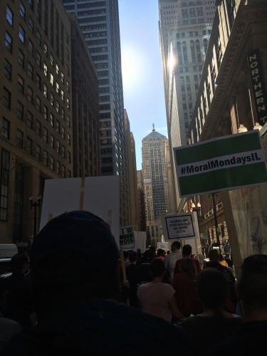 Protesters marched up LaSalle Street on Monday to protest cuts in social services. (ELLIE BRAIDA | THE DEPAULIA)