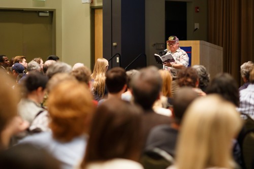 A veteran reads from "I Remember: Chicago Veterans of War" in the Lincoln Park Student Center. The event was organized by graduate students. (Connor O'Keefe / The DePaulia)