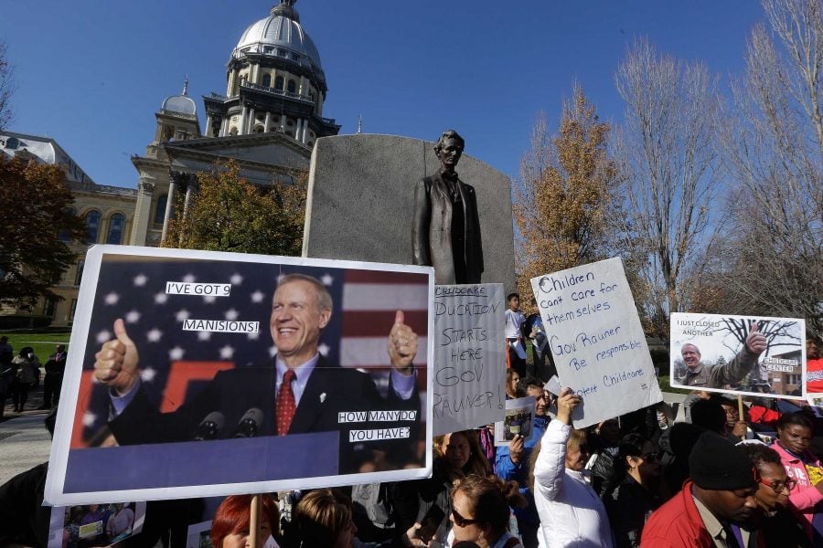 Protesters rally in support of lawmakers ending the state budget impasse at the Illinois State Capitol Tuesday, Nov. 10, 2015, in Springfield, Ill. Gov. Bruce Rauner offered more of what he called compromise to recalcitrant Democrats Tuesday, suggesting in a memo to lawmakers that he has reversed course and will support legislation to free up already collected tax dollars for distribution to local governments.  (AP Photo/Seth Perlman)