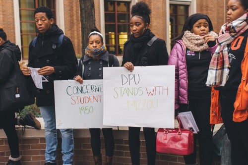 Whytne Stevens, freshman (center) holds a sign Thursday expressing support of students at the University of Missouri protesting racial discrimination. (Josh Leff / The DePaulia)