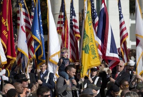 Honor guards carry the colors as they are retired at the conclusion of the annual National Veterans Day commemoration, Wednesday, Nov. 11, 2015, at Arlington National Cemetery in Arlington, Va., attended by President Barack Obama. (AP Photo/Manuel Balce Ceneta)