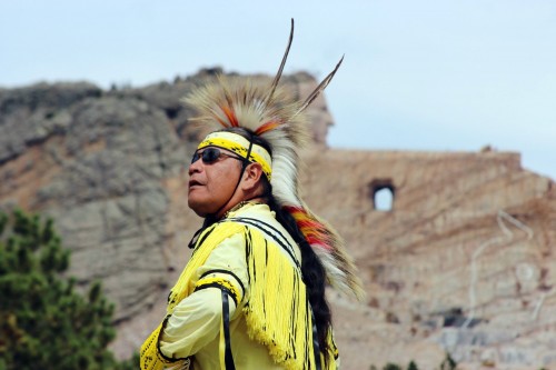 A Native American dancer shows the steps of traditional dances at the Crazy Horse Memorial in southwest South Dakota, 17 miles from Mount Rushmore. With the 87-foot-tall head of Crazy Horse finished and sculptors working on the outstretched arm, it is progressing - but it will likely be beyond our lifetimes before the world's biggest sculpture is finished. (Ellen Creager/Detroit Free Press/MCT)