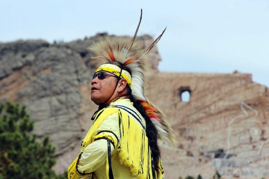 A Native American dancer shows the steps of traditional dances at the Crazy Horse Memorial in southwest South Dakota, 17 miles from Mount Rushmore. With the 87-foot-tall head of Crazy Horse finished and sculptors working on the outstretched arm, it is progressing - but it will likely be beyond our lifetimes before the worlds biggest sculpture is finished. (Ellen Creager/Detroit Free Press/MCT)