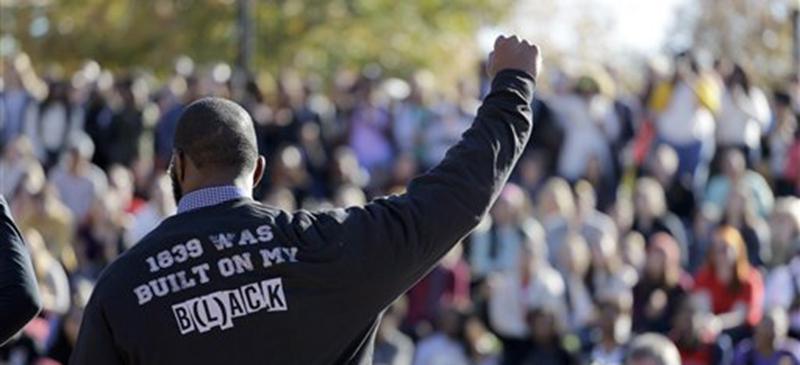 FILE - In this Nov. 9, 2015 file photo, a member of the black student protest group Concerned Student 1950 gestures while addressing a crowd following the announcement that University of Missouri System President Tim Wolfe would resign, at the university in Columbia, Mo. Few paid attention when a black student started a hunger strike at the University of Missouri to protest racial strife on campus. As soon as the football team supported that hunger strike by refusing to practice for or play in the schoolís lucrative NCAA games, the universityís president and chancellor were forced out and changes were discussed.  (AP Photo/Jeff Roberson, File)