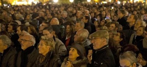 People gather outside for a national service for the victims of the terror attack at Notre Dame cathedral in Paris, Sunday, Nov. 15, 2015. Thousands of French troops deployed around Paris on Sunday and tourist sites stood shuttered in one of the most visited cities on Earth while investigators questioned the relatives of a suspected suicide bomber involved in the country's deadliest violence since World War II. (AP Photo/Daniel Ochoa de Olza)