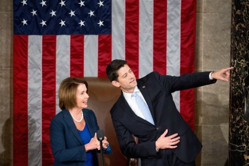 Newly elected Rep. Paul Ryan of Wis., accompanied by House Minority Leader Nancy Pelosi of Calif., points towards his family in the gallery in the House Chamber on Capitol Hill in Washington, Thursday, Oct. 29, 2015. Republicans rallied behind Ryan to elect him the House's 54th speaker on Thursday as a splintered GOP turned to the youthful but battle-tested lawmaker to mend its self-inflicted wounds and craft a conservative message to woo voters in next year's elections. (AP Photo/Andrew Harnik)