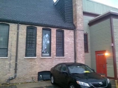 The Church of Our Savior’s soup kitchen is located through one of the building’s side doors. Guests often socialize next to the church parking lot. (JACKSON DANBECK | THE DEPAULIA)