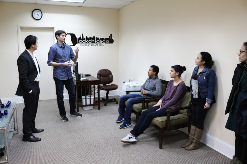 Owners Brian Lee and Bane Srdjevic give instructions to players before they enter their escape room, Lock Chicago. The escape room is located in Evanston, and offers attendees a chance to solve puzzles in order to get out of a room.  (Jesus Montero / The DePaulia)