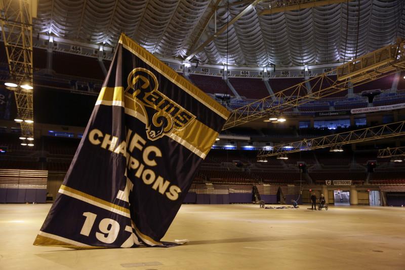 Championship banners are removed from the ceiling of the Edward Jones Dome, former home of the St. Louis Rams football team, Thursday, Jan. 14, 2016, in St. Louis. The Rams will begin playing in Los Angeles starting with the 2016 season. (AP Photo/Jeff Roberson)