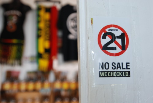 In this Tuesday, Dec. 29, 2015 photo, retailer Holy Smokes has signs posted around its entryway to alert customers to the state's new smoking laws in Honolulu. Hawaii is the first state in the nation to raise the legal smoking age to 21-years-old, for traditional and electronic cigarettes. The law goes into effect on New Year's Day. (AP Photo/Cathy Bussewitz)