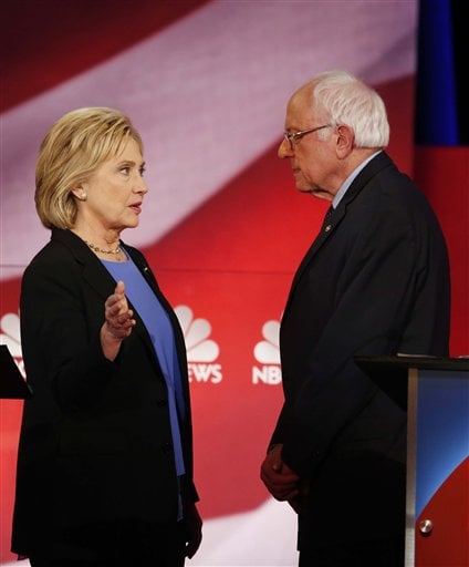 Democratic presidential candidate, Hillary Clinton and Democratic presidential candidate, Sen. Bernie Sanders, I-Vt. speak during a break at the NBC, YouTube Democratic presidential debate at the Gaillard Center, Sunday, Jan. 17, 2016, in Charleston, S.C. (AP Photo/Mic Smith)