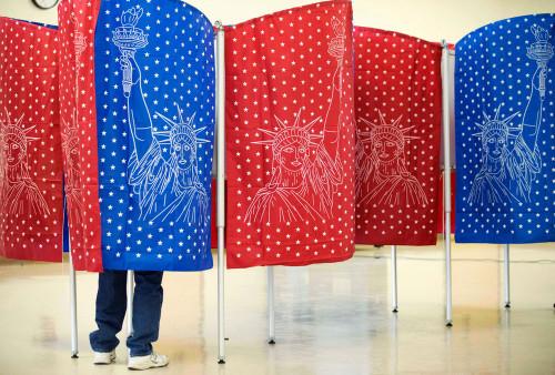 A voter marks a ballot for the New Hampshire primary inside a voting booth at a polling place Feb. 9 in Manchester, New Hampshire. (David Goldman / AP Photo)