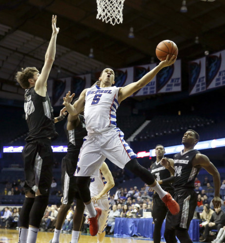 DePaul guard Billy Garrett Jr. (5) shoots against Providence guard Ryan Fazekas, left, as Providence's Kyron Cartwright (24) watches during the second half of an NCAA college basketball game Tuesday, Feb. 2, 2016, in Rosemont, Ill. DePaul upset Providence, 77-70. (AP Photo/Charles Rex Arbogast)