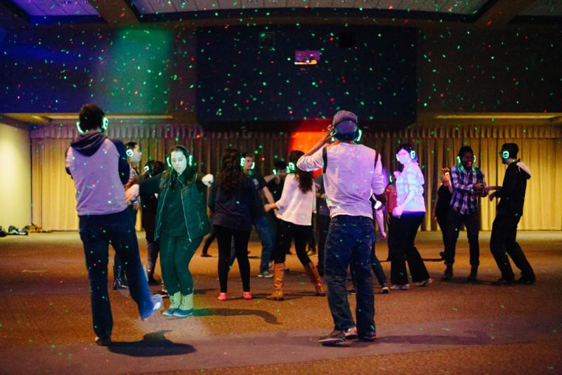 Students dance at the Silent Disco organized by DePaul Activities Board (DAB). At the disco, students were given headphones, and only through the headphones could attending students hear the music. (Garrett Duncan / The DePaulia) 