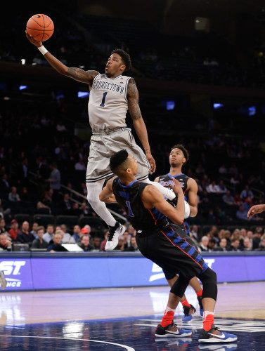 Georgetown guard Tre Campbell, top, shoots shot against DePaul guard Darrick Wood (1) in the first half of an NCAA college basketball game during the Big East men's tournament Wednesday, March 9, 2016, in New York. Campbell was called for an offensive foul on the play. (AP Photo/Julie Jacobson)