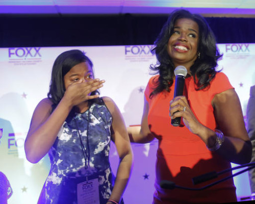 Challenger Kim Foxx , right, smiles at the crowd as her daughter Kai, wipes tears from eyes, as they celebrate Foxx's primary win over incumbent Democratic Cook County State's Attorney Anita Alvarez Tuesday, March 15, 2016, in Chicago. (AP Photo/Charles Rex Arbogast)