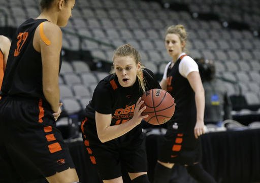 Oregon State guard Jamie Weisner (15) runs a drill with teammate forward Deven Hunter (32) during a college basketball practice in the regional semifinals of the women's NCAA Tournament, Friday, March 25, 2016, in Dallas. Oregon State takes on DePaul on Saturday. (AP Photo/LM Otero)