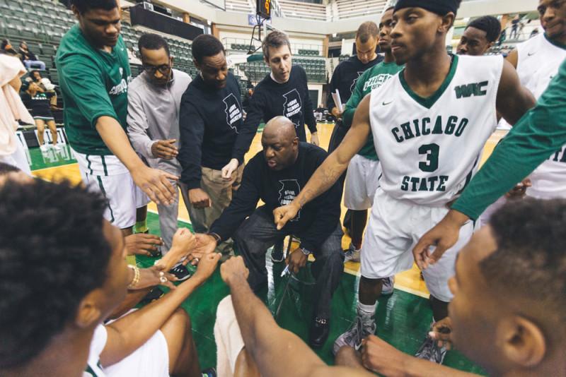Chicago State University head coach Tracy Didly gathers his players before a game against University of Missouri-Kansas Saturday. The game could be the last for the school. (Geoff Stellfox / The DePaulia)