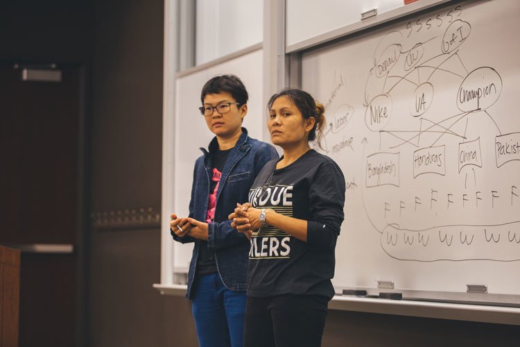 Noi Supalai (right), a former garment worker from Bangkok, Thailand spoke to DePaul students Thursday about her experiences working at a Thai clothing factory. (Josh Leff / The DePaulia)