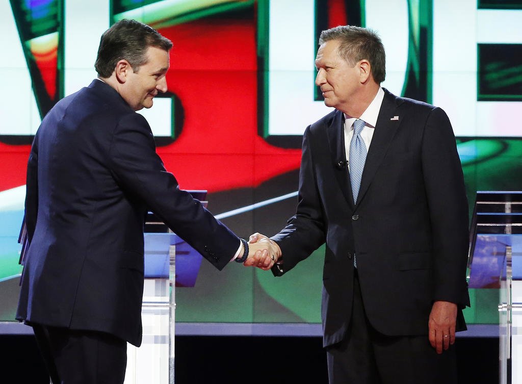 FILE - In this March 10, 2016, file photo, Republican presidential candidate, Sen. Ted Cruz, R-Texas, left, shakes hands with Republican presidential candidate, Ohio Gov. John Kasich, at the start of a Republican presidential debate sponsored by CNN, Salem Media Group and the Washington Times at the University of Miami in Coral Gables, Fla. The political world is waiting to see if Cruz and Kasichs alliance against Donald Trump proves brilliant or desperate. Some voters in the three states most affected are applauding the move and others are panning it. But many are struggling to understand what, if anything, it will mean for them.(AP Photo/Wilfredo Lee, File)
