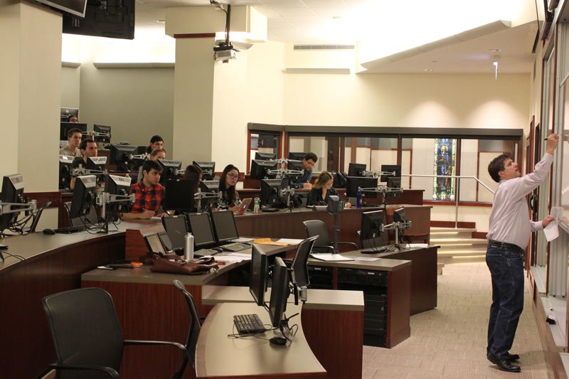 Professor Keith Gamble gives a lecture to his Finance 330 students in DePaul’s Finance Lab. Gamble teaches about investments and encourages students to invest early. (Jack Higgins / The DePaulia)